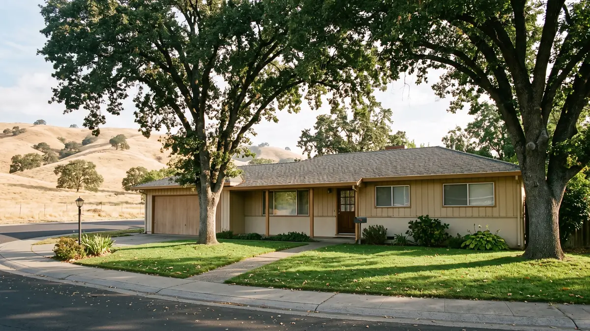 Tan board-and-batten ranch under two valley oaks with golden hills behind — slab leak detection in San Lorenzo, CA